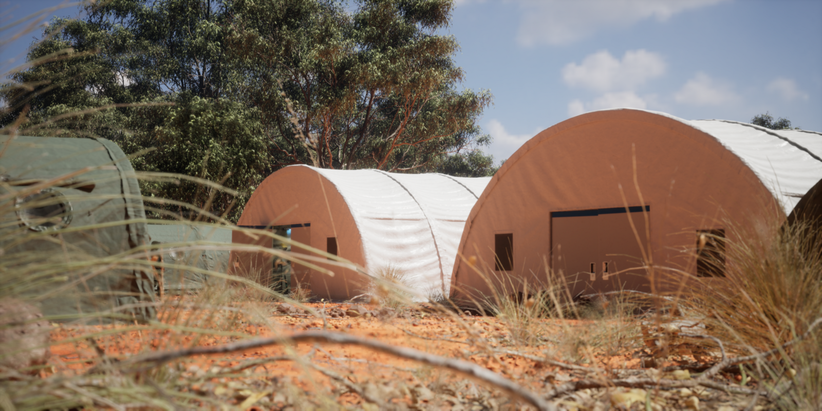 Exterior view of field medical tents set up in a natural environment